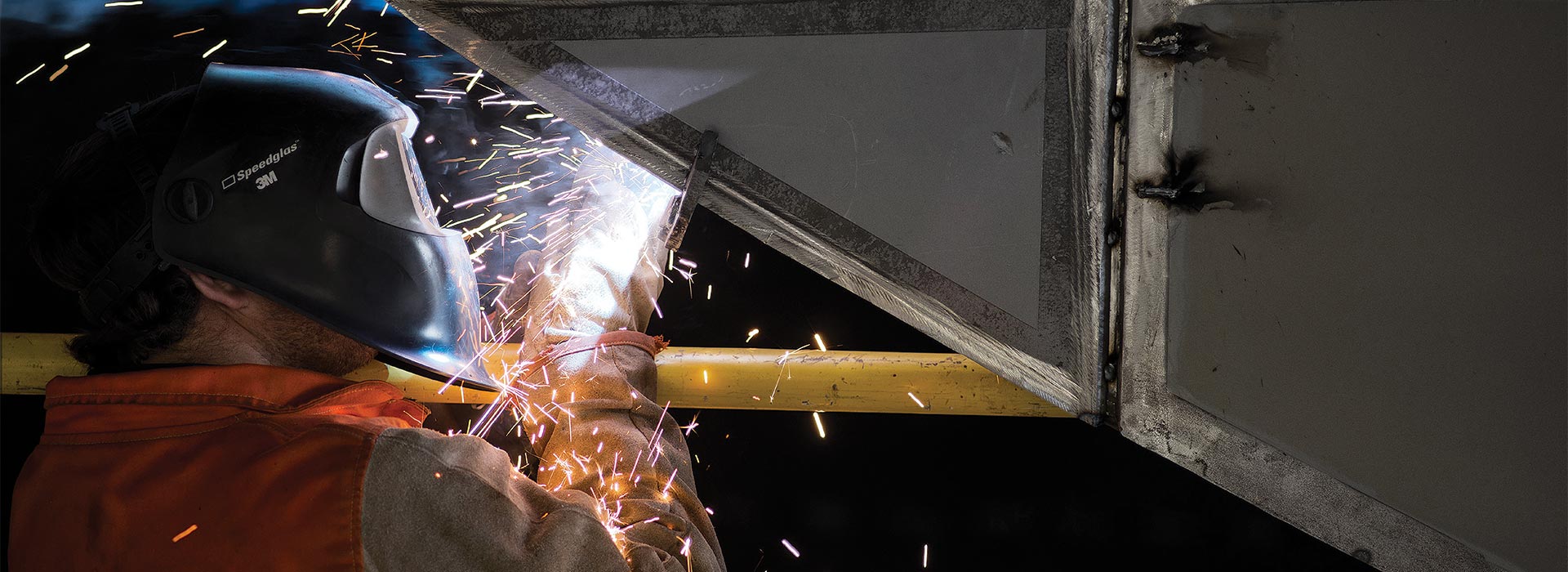 Defence contractor welding a steel component